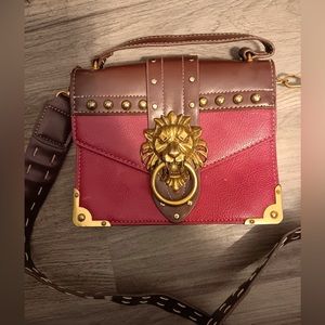 Red and gold, lion hanger purse. Never used. Over the shoulder strap.